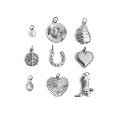 Collection of various silver western charms on a white background