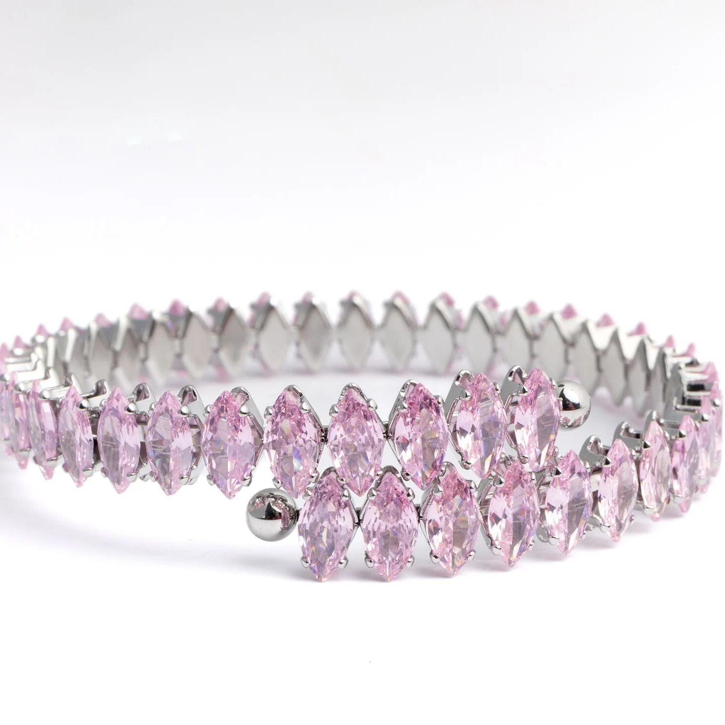 Pink tiara with silver accents on a white background
