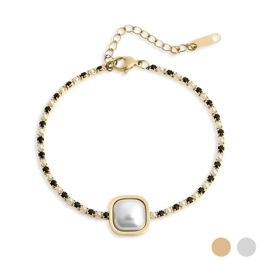 Gold bracelet with a central pearl and black stones on a white background