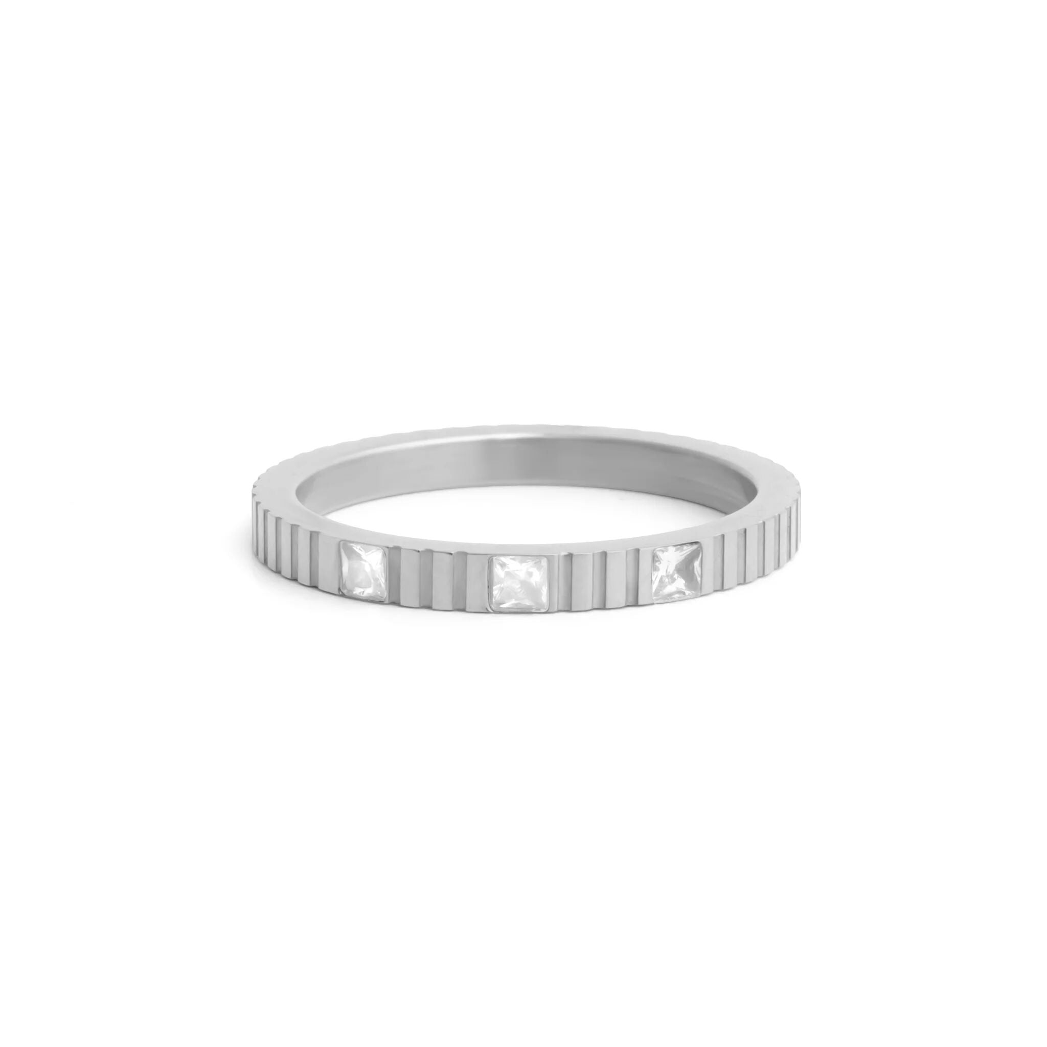 Silver ring with embedded stones on a white background