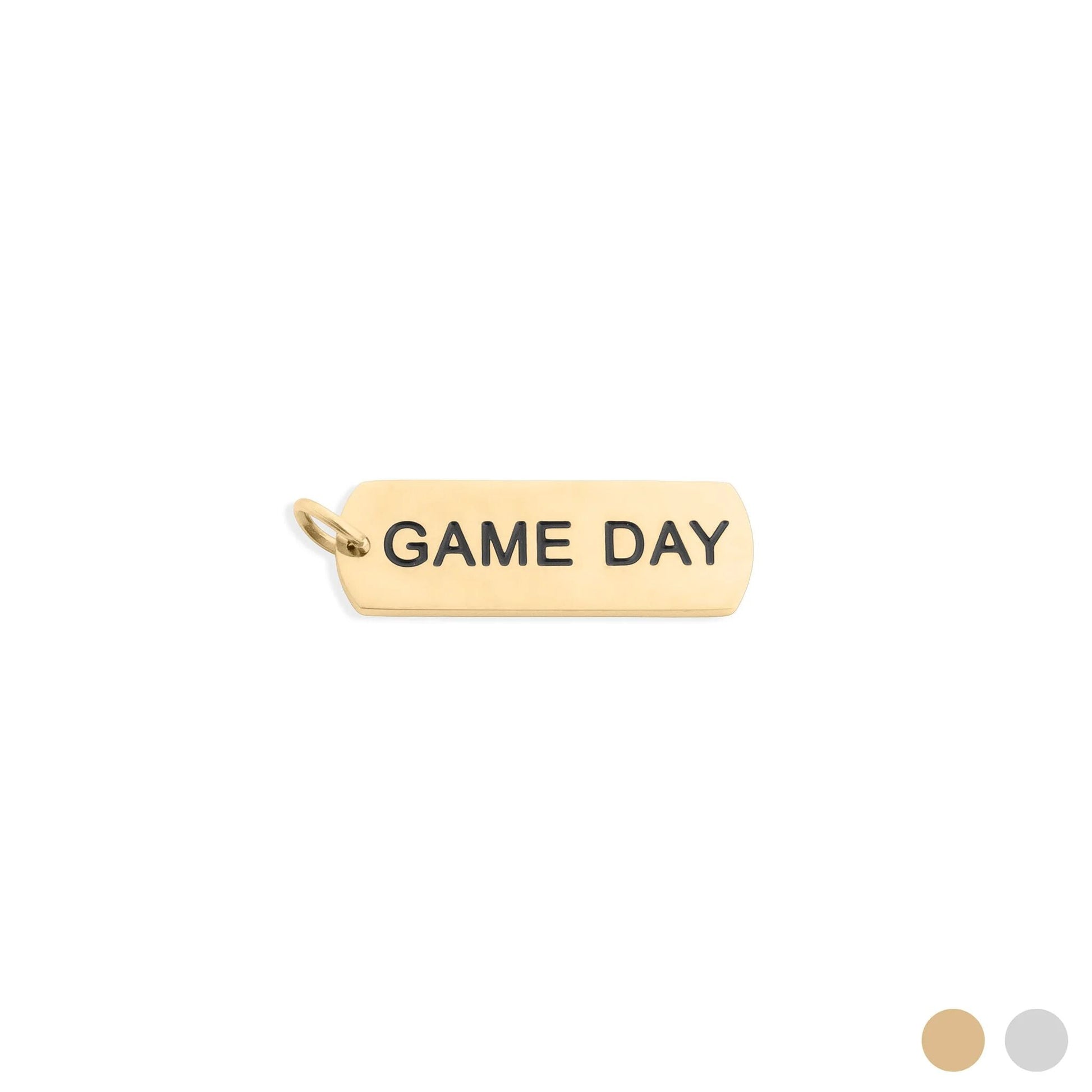 Gold pendant with 'GAME DAY' engraving on a white background